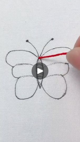 someone is drawing a butterfly with red thread