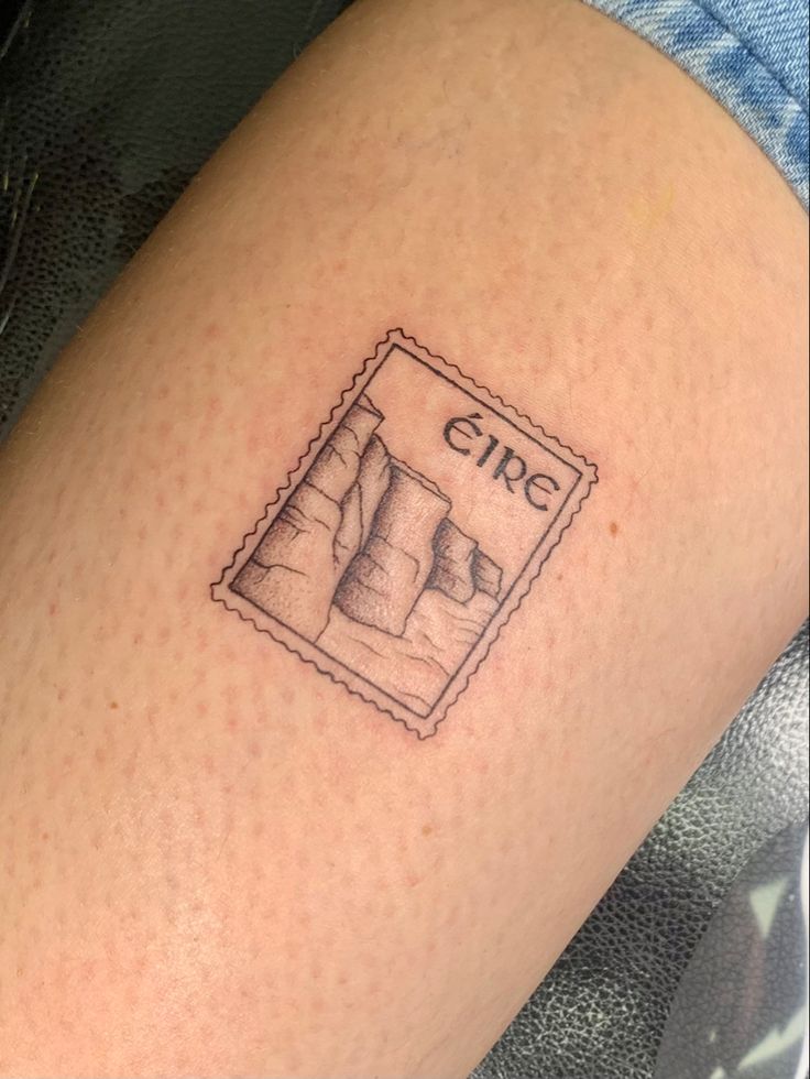 a person with a small tattoo on their arm that reads girl and has a stamp in it