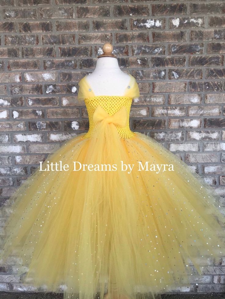 "Welcome to Little Dreams by Mayra This dress is absolutely adorable, very very puffy and sparkly! It has four layers of tulle that makes it very puffy and princess style, skirt is made with yellow tulle and sparkly yellow tulle. Straps of the dress are made with tulle, thus straps go to the back and you must tight them with a bow or knot, little gems are glued to the straps, very very pretty, I don't think pictures show how gorgeous this dress is! your little one will feel like a real princess Yellow Tulle Dress For Birthday, Yellow Ruffled Tutu Dress For Wedding, Yellow Wedding Tutu Dress With Ruffles, Cute Yellow Princess Dress For Party, Yellow Tulle Tutu Dress For Party, Cute Yellow Princess Party Dress, Cute Yellow Tutu Dress For Party, Yellow Princess Wedding Dress, Yellow Princess Style Wedding Dress