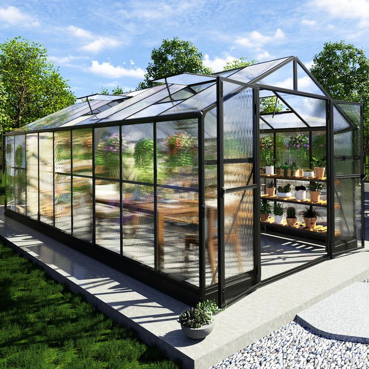 a glass house sitting in the middle of a lush green field with lots of plants