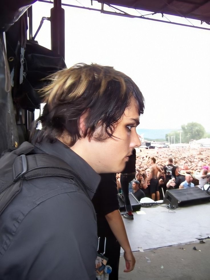 a man standing in front of a crowd at a concert