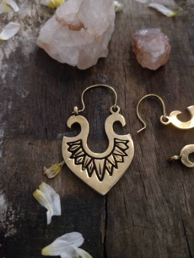 Elevate your boho style game with these stunning Tribal Danglers. Handmade with love and attention to detail, these earrings feature a gorgeous vintage boho design that is sure to set you apart from the crowd. Made with high-quality brass, these earrings offer both durability and unique charm. Whether you're dressing up for a casual evening or a romantic date night, these earrings are the perfect accessory to complete your look. Don't miss your chance to add these beautiful and one-of-a-kind earrings to your collection. Order now and embrace the beauty of bohemian style with our Tribal Danglers. Bohemian Teardrop Jewelry With Ear Wire, Bohemian Bronze Drop Earrings, Bohemian Chandelier Earrings With Ear Wire For Festivals, Bohemian Chandelier Earrings For Pierced Ears, Bohemian Bronze Chandelier Earrings With Ear Wire, Bohemian Teardrop Hoop Earrings With Ear Wire, Bohemian Metal Dangle Hoop Earrings, Bohemian Metal Plug Earrings For Pierced Ears, Bohemian Bronze Earrings With Ear Wire