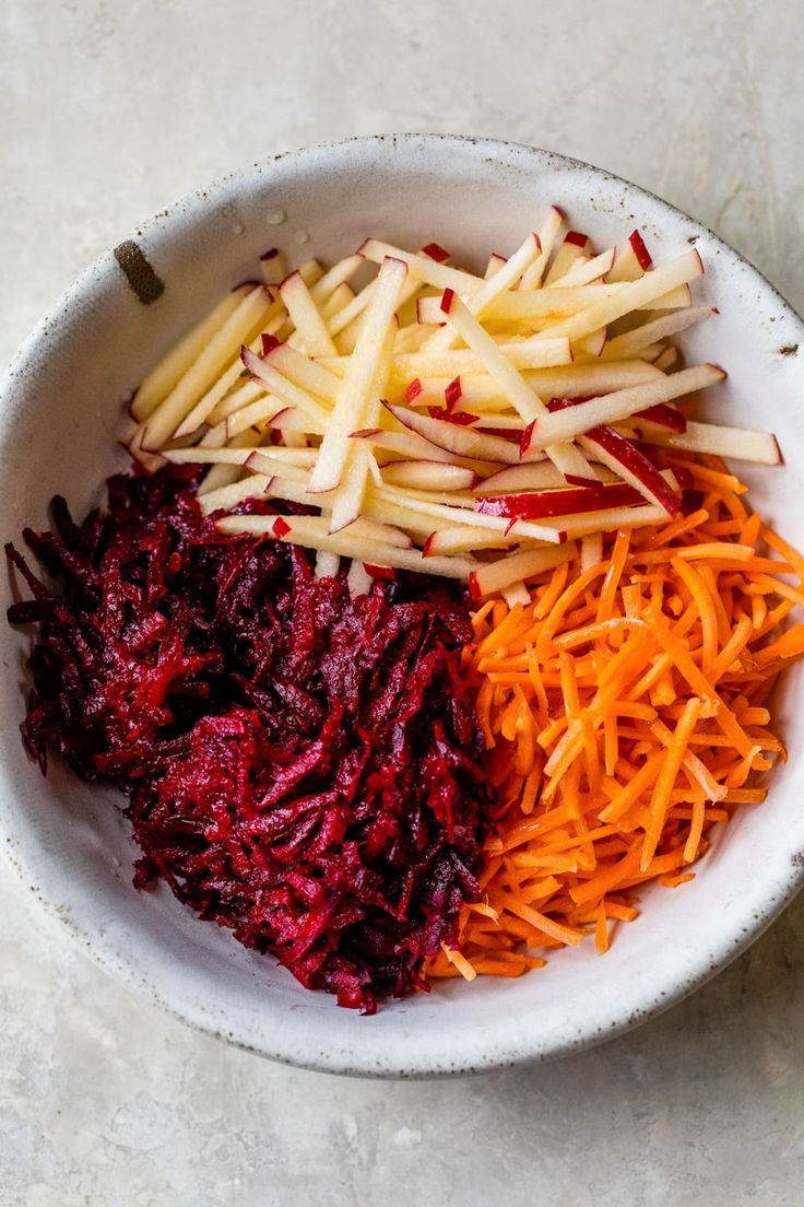 carrots, beets and shredded cheese in a bowl