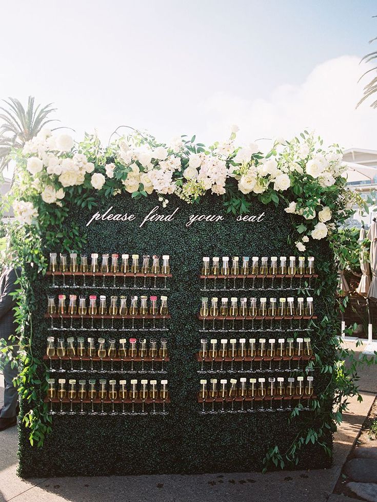 an outdoor display with flowers and wine bottles