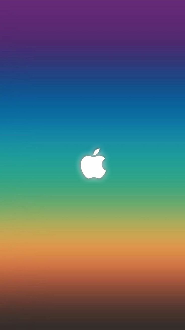 an apple logo is shown in the middle of a blurry background with orange, blue and green colors