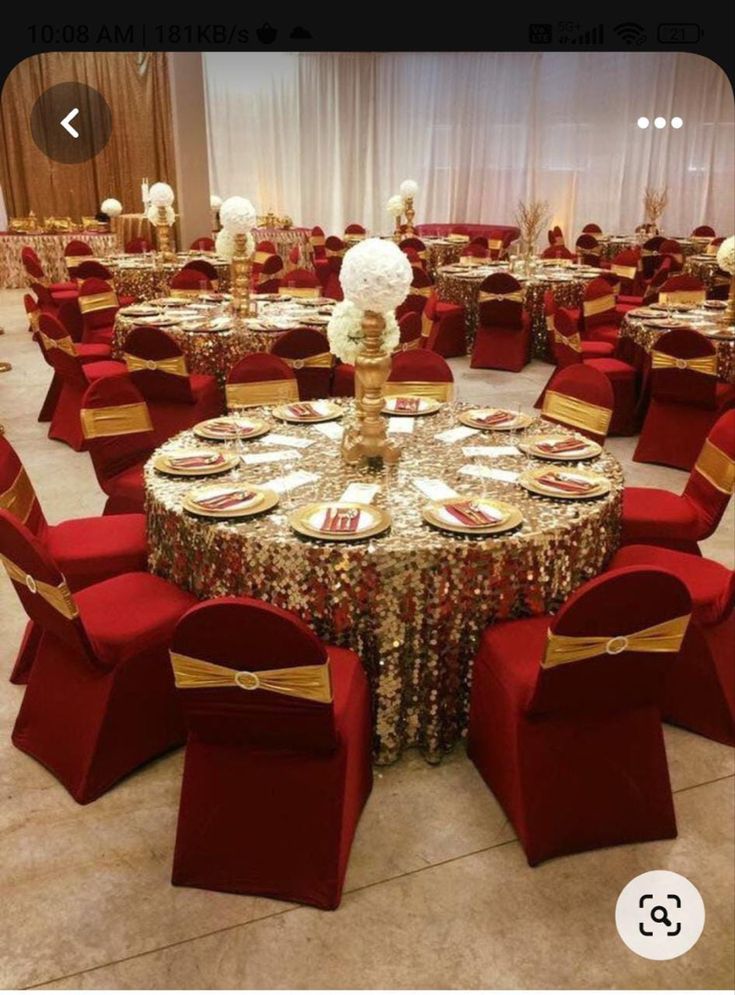 a banquet room set up with red chairs and gold table cloths