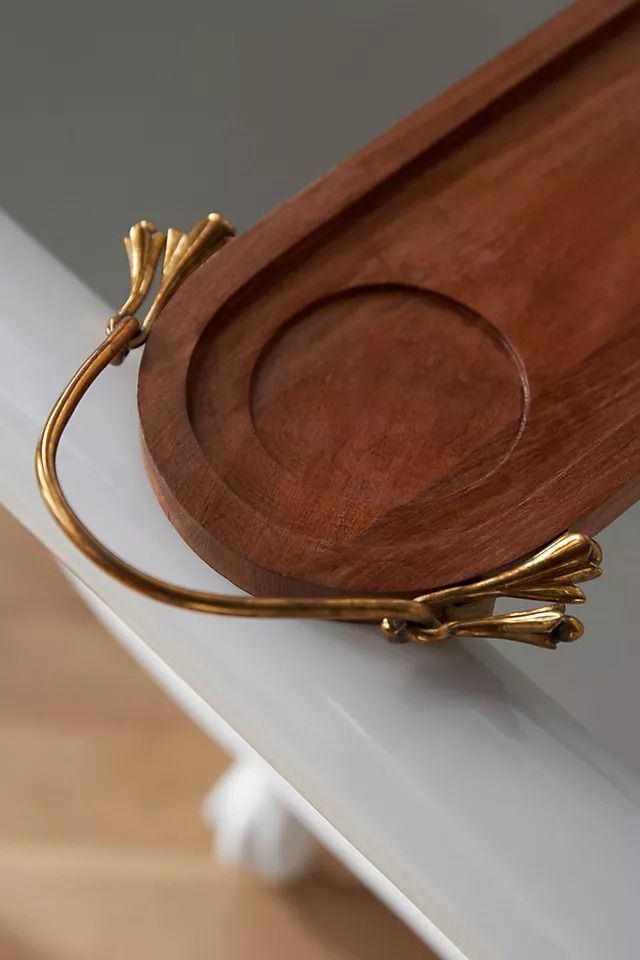 a wooden tray sitting on top of a white table