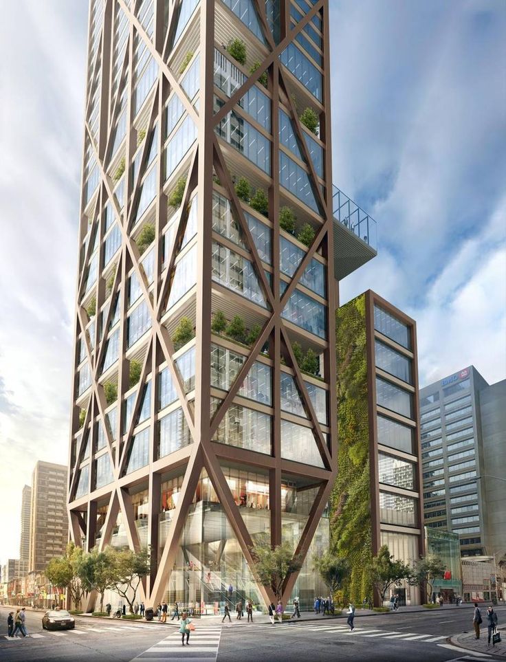 a tall building with lots of windows and plants growing on the top of it's sides