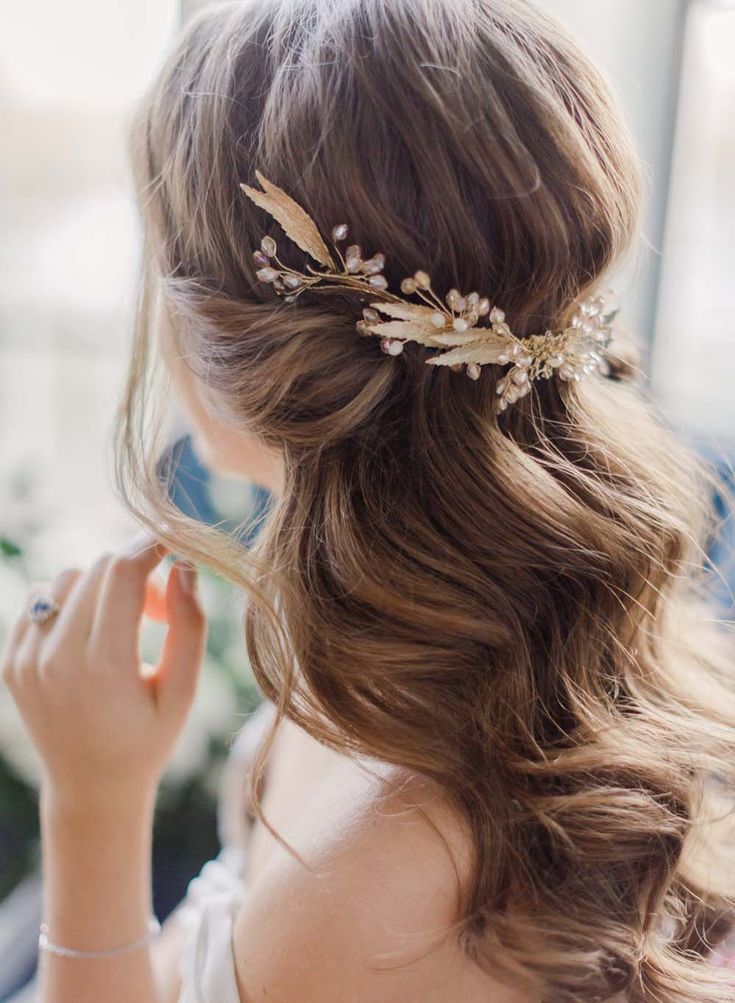 a woman wearing a hair comb with leaves on it