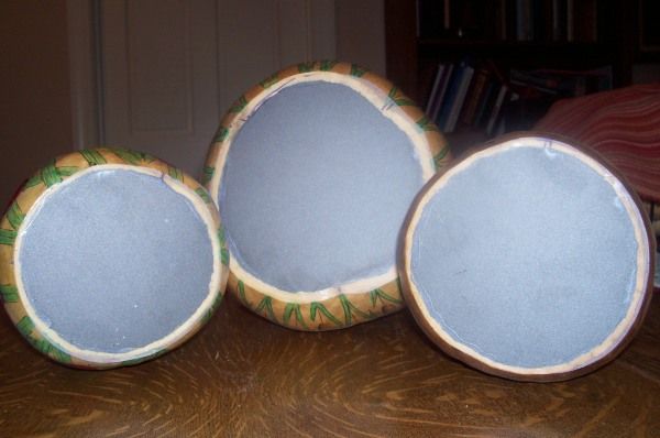 three speakers sitting on top of a wooden table