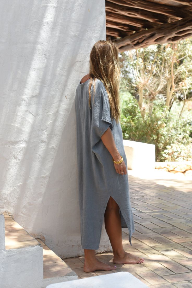 Style // The ultimate stormy blue kaftan is perfect for any occasion When comfort meets style, the Cala Kaftan features a billowy, shapeless silhouette and mid-length. With a v-neck silhouette, wide sleeves and two side slits, it promises to be your go-to look for that cozy, effortless look. The lightweight linen-cotton blend fabric is extra soft, to ensure you won't ever want to take it off Fabric Note // Made in Italy from a Linen & Cotton blend Sizing Advice // Available in one size, for an o Casual V-neck Kaftan For Daywear, Blue Oversized Kaftan For Loungewear, Oversized Blue Kaftan For Loungewear, Blue Relaxed Fit V-neck Tunic, Casual V-neck Relaxed Fit Kaftan, Oversized V-neck Kaftan For Loungewear, Relaxed Fit V-neck Tunic For Loungewear, Blue V-neck Kaftan For Loungewear, Oversized Blue Casual Kaftan