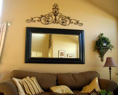 a living room filled with furniture and a mirror