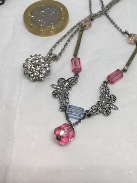 A small collection of necklaces in good condition. An art glass bead and pearl in blues and pinks. A gem encrusted heart, a lovely diamante dome and a pink and blue crystal necklet featuring butterflies. As a job lot, and priced to find a new home. Vintage Style Metal Necklaces With Charms, Dainty Metal Necklaces With Vintage Charm, Vintage Collection Round Pendant Necklaces With Charms, Vintage Collection Round Pendant Necklace With Charms, Vintage Beaded Crystal Necklaces, Vintage Round Beaded Crystal Necklaces, Handmade Vintage Crystal Necklaces For Party, Handmade Vintage Crystal Necklace For Parties, Costume Jewelry Rhinestone Pendant Necklace