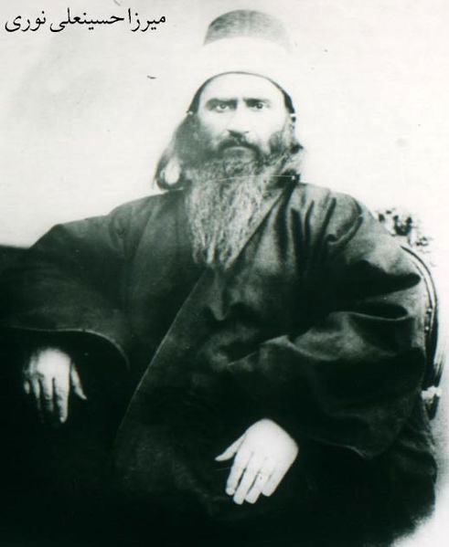 an old black and white photo of a man with a long beard sitting in a chair