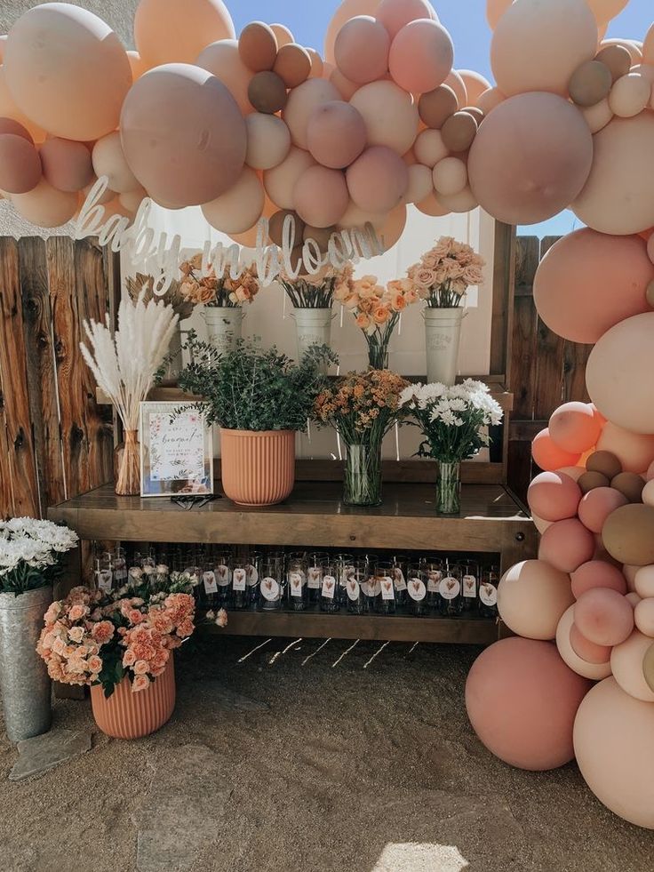 a table topped with lots of balloons and flowers