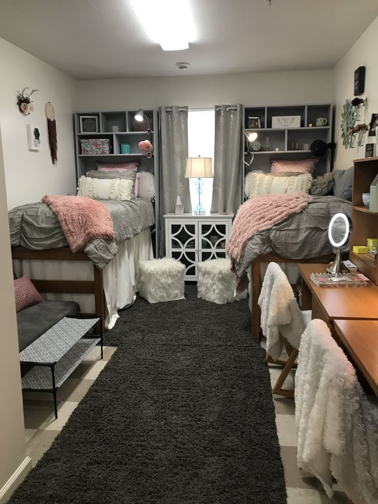 a bedroom with two beds and a rug on the floor