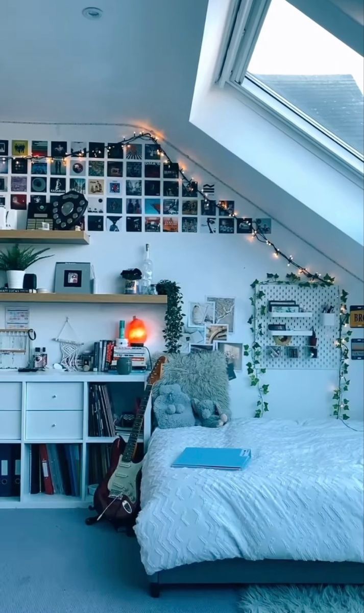 an attic bedroom with lots of books and pictures on the wall