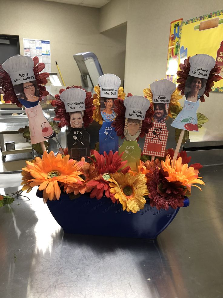 a blue bowl filled with flowers and paper hats