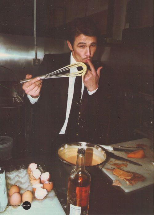 a man in a suit and tie is preparing food