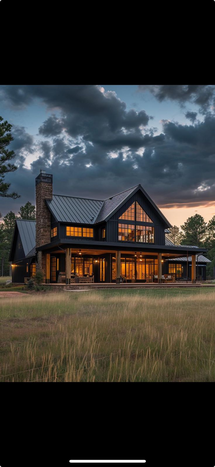 a large house sitting on top of a lush green field next to a tall grass covered field