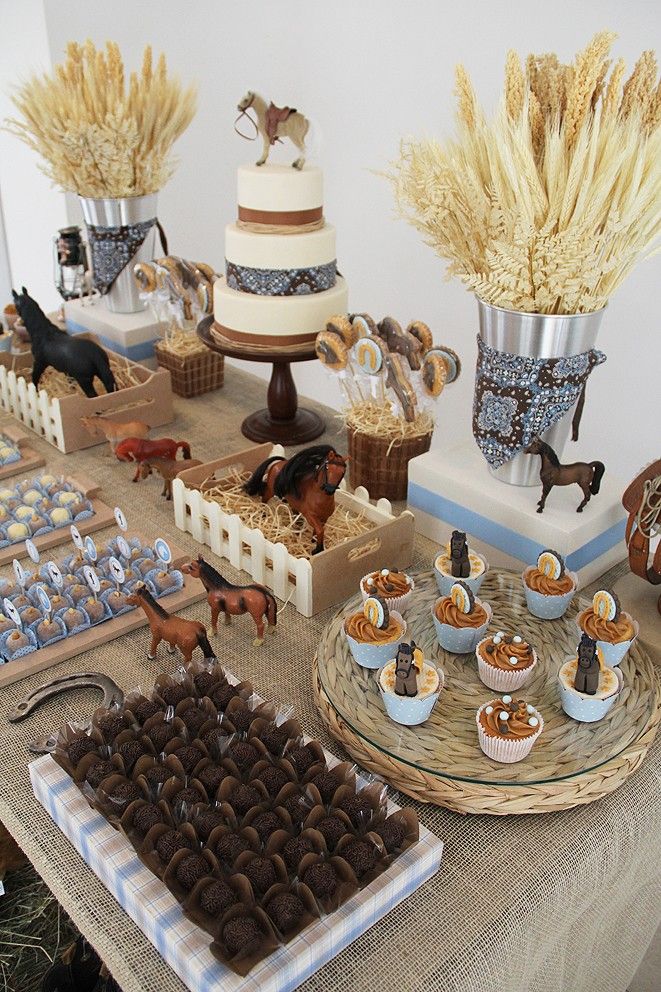 a table topped with cakes and desserts covered in frosting