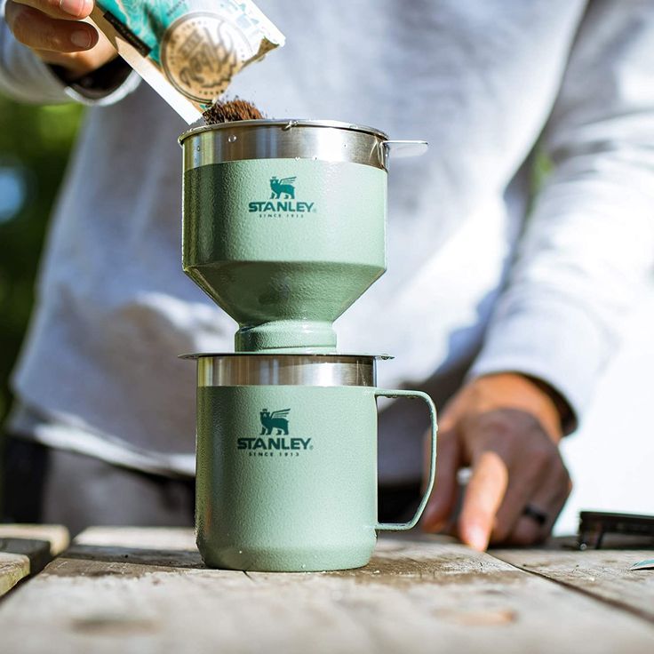 a person pouring something into a cup