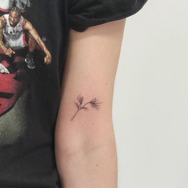 a woman's arm with a small tattoo on it