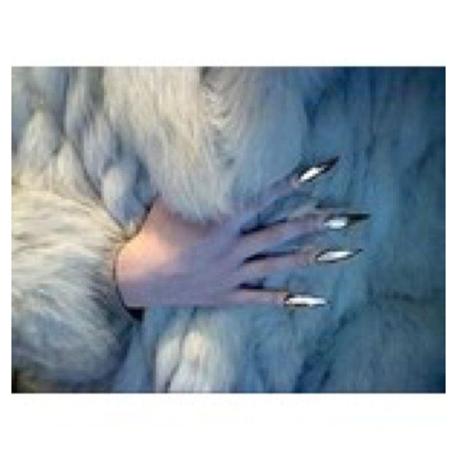 a woman with long nails and white fur