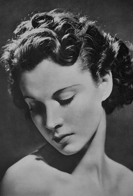 an old black and white photo of a woman with her eyes closed