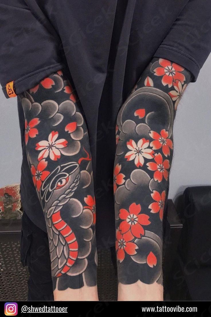 the legs and arms of a person with tattoos on their body, both covered in red flowers