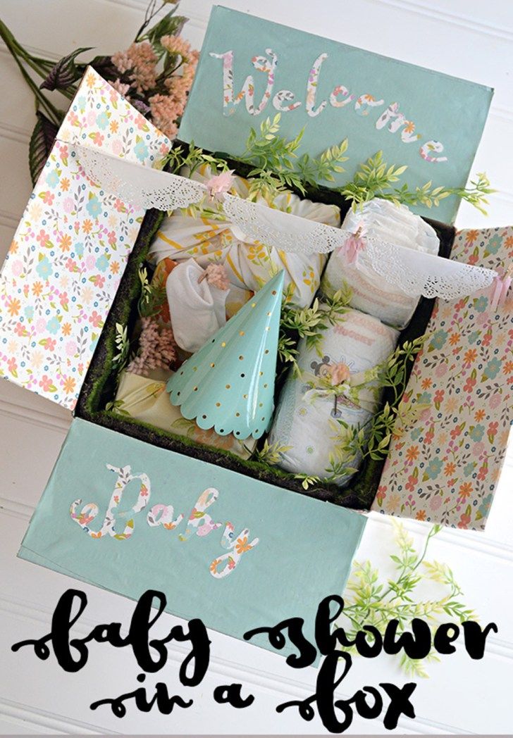 a baby shower in a box with flowers