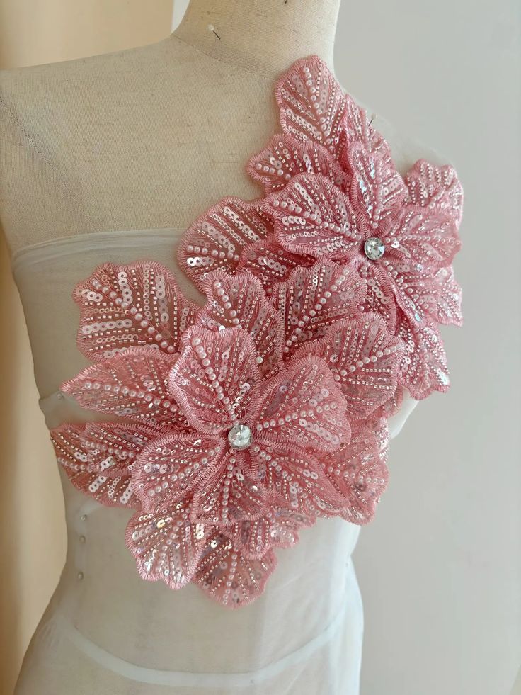 a close up of a mannequin wearing a dress with pink flowers on it