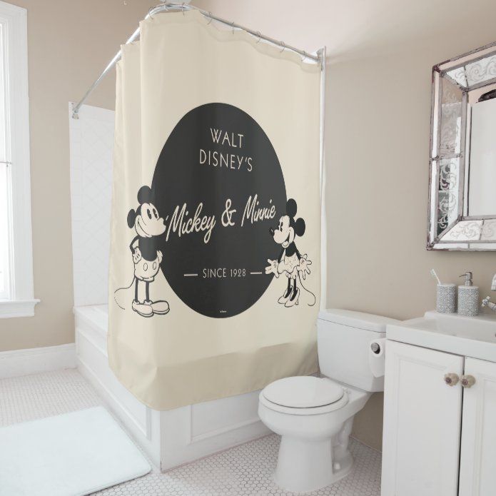 a bathroom with a mickey and minnie shower curtain