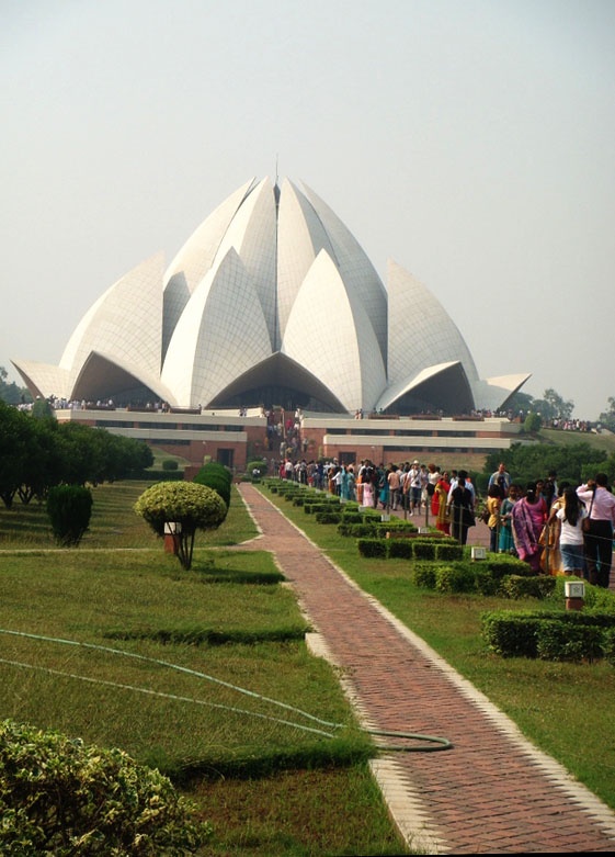 people standing in front of a large building with many domes on it's sides