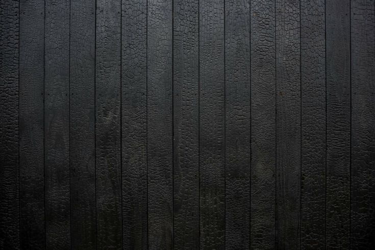 an image of a black wall that looks like it is made out of wood planks