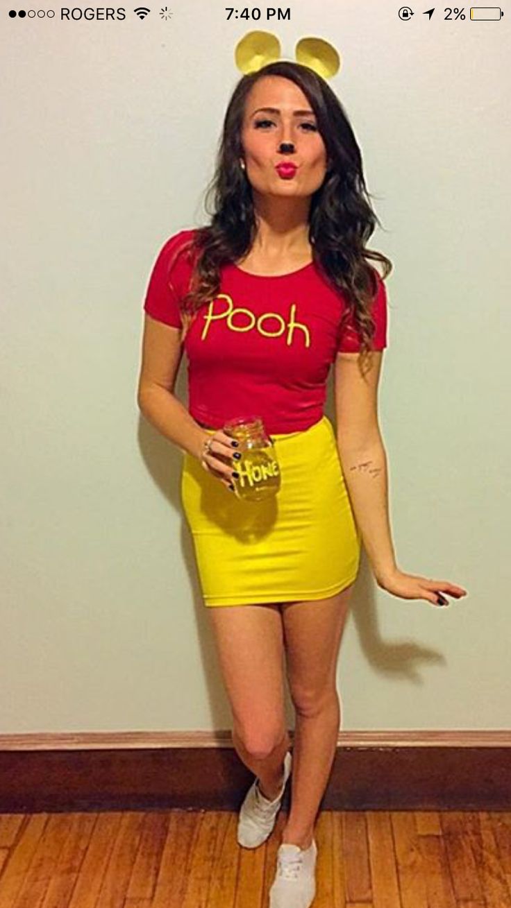 a woman in a red shirt and yellow skirt with mickey mouse ears on her head