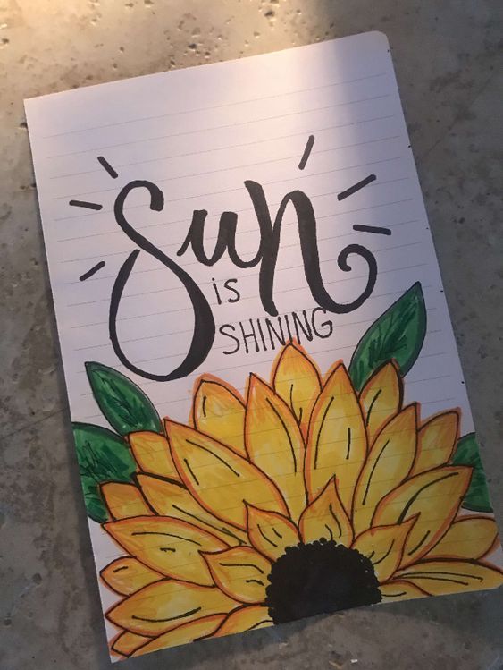 a notepad with the words sup is shining on it and a sunflower painted on top