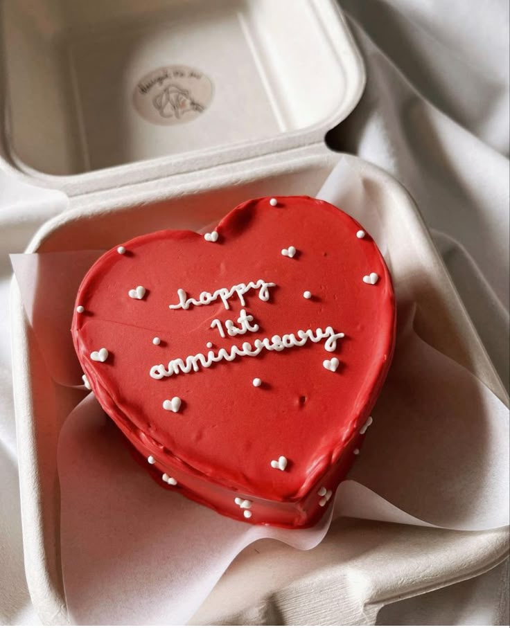 a red heart shaped cake in a box with writing on it that says, support the grandmama