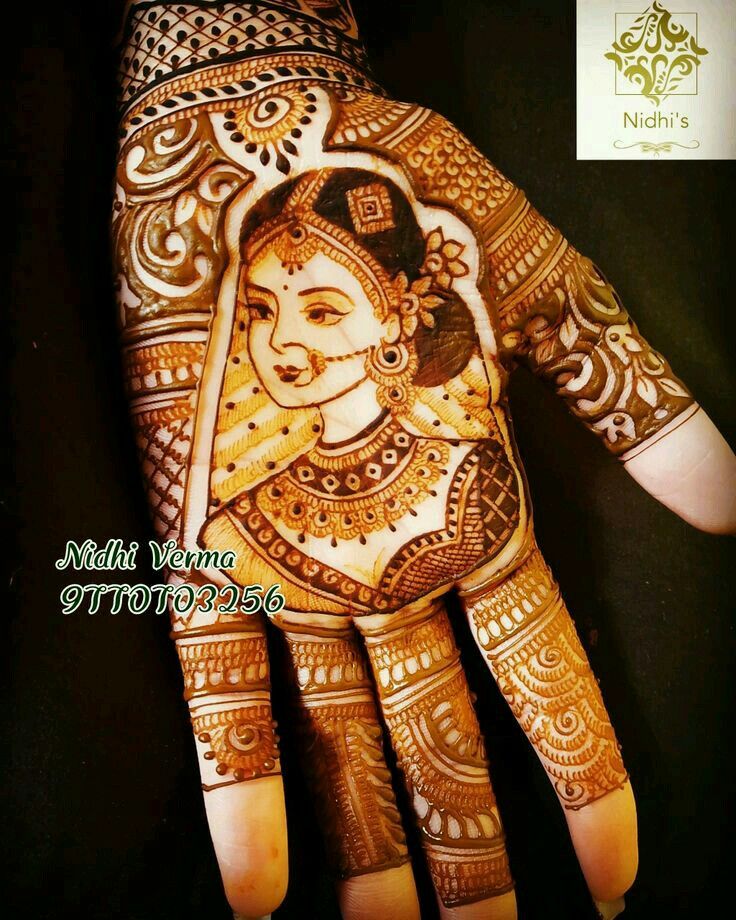 the hand is decorated with henna designs