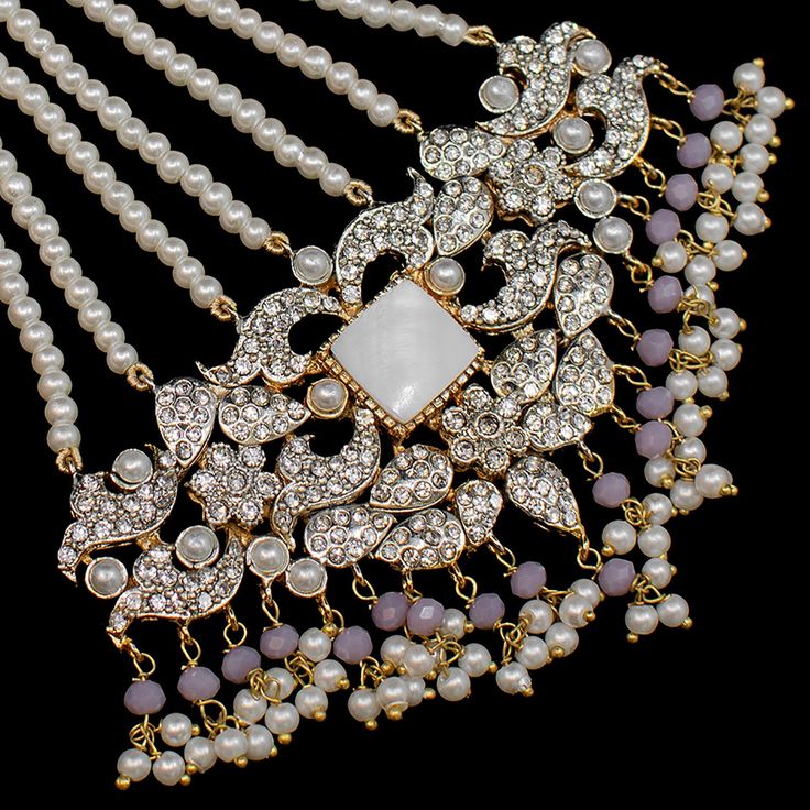 This royal set is sure to make you feel like a queen! A classic layout of CZ stones strung in harmony with pearl beads. The set includes a choker paired with a necklace and a mala, a matching maang teekah, a jhoomar, a pair of haathphools and a pair of beautiful jhumkey earrings. Approximate earrings length is 3.5". Gold-plated on high-quality brass as base metal. Made by order. Kindly allow 4-6 weeks for the delivery of this item. For custom or urgent requests, please contact support@alacouture Cz Stone, A Necklace, Base Metal, Pearl Beads, Diamond Necklace, Choker, Pearl Necklace, Gold Plate, Layout