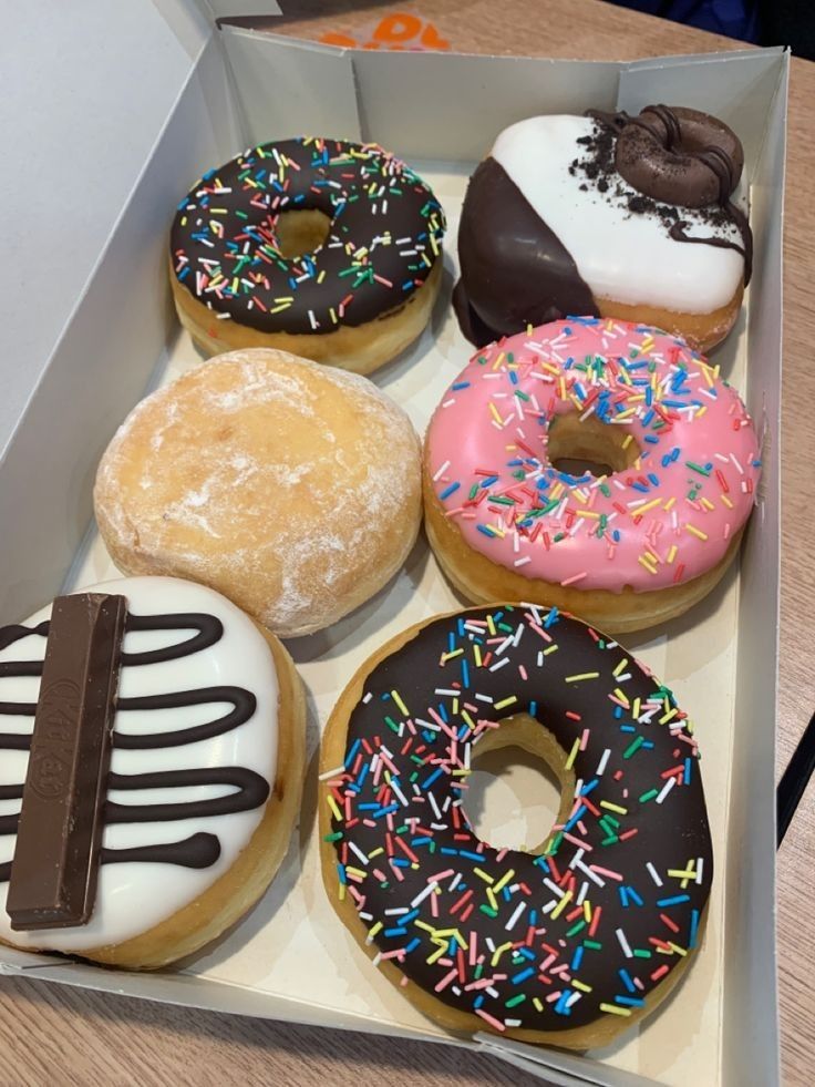 a box filled with lots of different flavored donuts