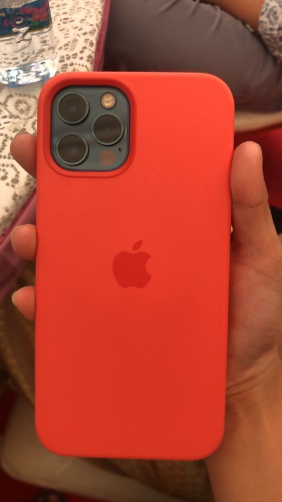 an apple phone case in someone's hand