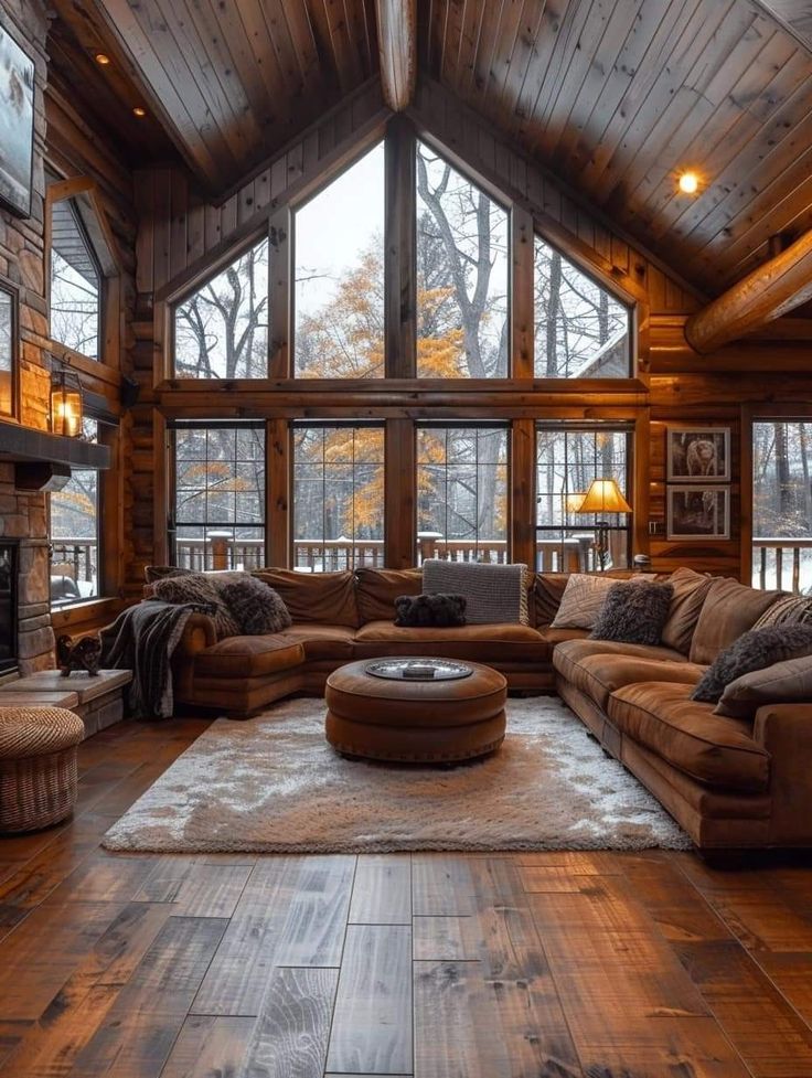 a large living room with wood floors and high vaulted ceilings is pictured in this image