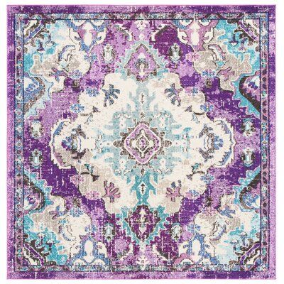 a purple and blue rug with an ornate design