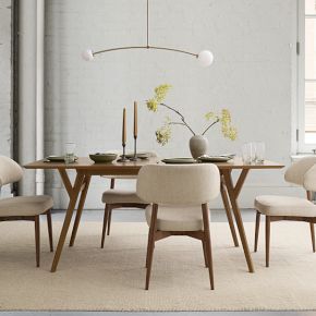 a dining room table and chairs with white walls