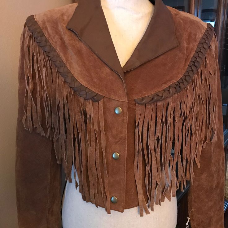 New With Tags Attached! “Leather Gallery” 100% Genuine Leather Jacket With Long Leather Fringe Details Front & Back. Two Slant Pockets With Braided Leather Trim. 100% Nylon Lined. Size Is X-Small - But Will Fit Size Small Too. Professional Leather Dry Clean Only. This Is An Exceptionally Beautiful Jacket! Brown Leather Long Sleeve Cropped Jacket, Brown Leather Cropped Jacket With Long Sleeves, Fall Leather Outerwear With Fringe, Fitted Western Leather Jacket With Long Sleeves, Leather Fringe Outerwear For Fall, Leather Outerwear With Fringe For Rodeo, Fall Leather Jacket For Rodeo, Leather Fringe Outerwear For Rodeo, Western Leather Outerwear With Fringe