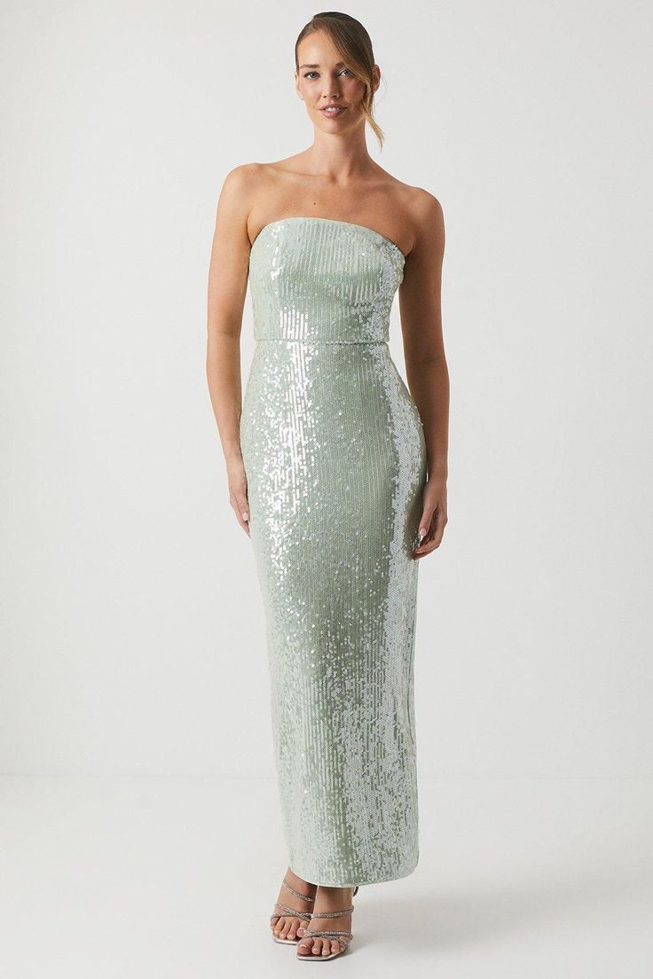 a woman wearing a strapless dress with sequins