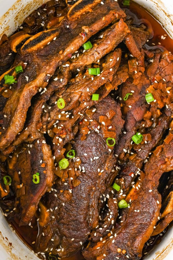 the meat is cooked and ready to be served in the pot with sesame seeds on top