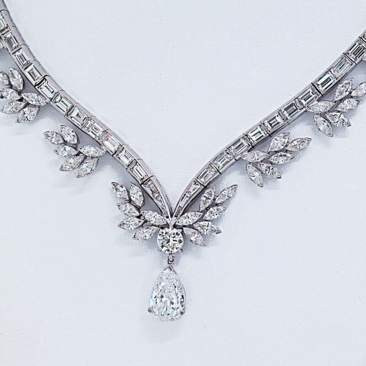 Indulge in the timeless elegance of the Raymond C. Yard Pear Shape Drop Diamond Necklace. This exquisite piece is a testament to the unparalleled craftsmanship and artistry that Raymond C. Yard is renowned for. With a captivating pear-shaped center diamond, certified by GIA, weighing an impressive 1.89 carats, this necklace is a true treasure.Every detail of this necklace is meticulously designed to create a stunning visual impact. The center diamond is delicately suspended, surrounded by a symp Classic Pear-shaped Bridal Necklace With 17 Jewels, Fine Jewelry Platinum Pear-shaped Diamond Necklace, Luxury Platinum Pear-shaped Necklace, Platinum Pear-shaped Diamond Necklace, Fine Jewelry Diamond Pear-shaped Bridal Necklace, Fine Jewelry Diamond Bridal Necklace Pear-shaped, Formal Pear-shaped Cubic Zirconia Diamond Necklace, Classic Pear-shaped Diamond Bridal Necklace, Pear-shaped Cubic Zirconia Diamond Necklace For Formal Occasions