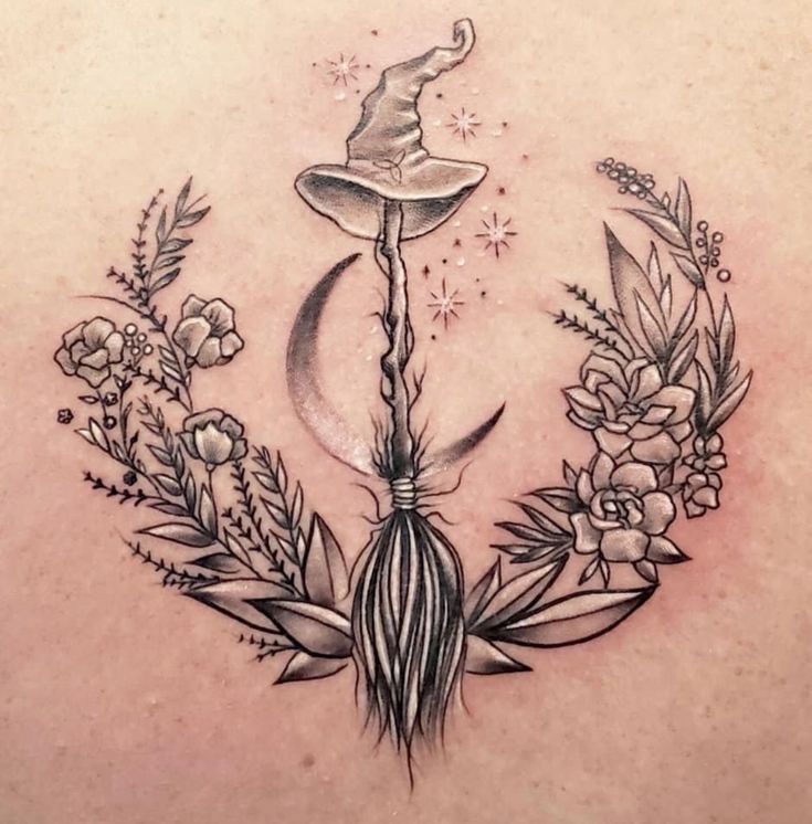 a woman's back with an image of a wizard hat and flowers on it